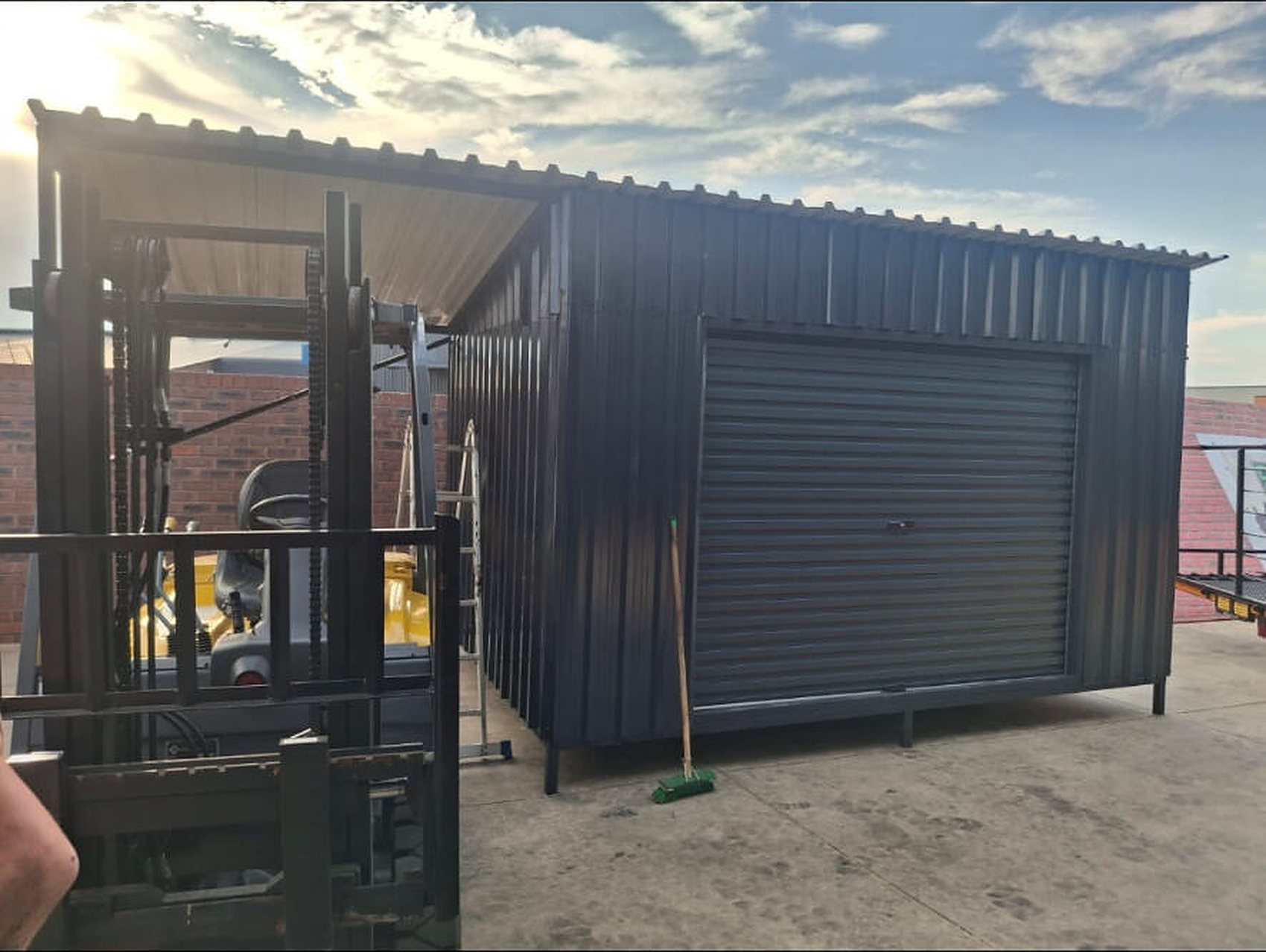 Steel unit with roller door, on site